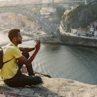 Traveler man doing photo on mobile phone. Porto, famous iron bridge and Douro rive on background ; Shutterstock ID 1086295274; your: Claire naylor; gl: 65050; netsuite: Online ed; full: Portugal best places
1086295274